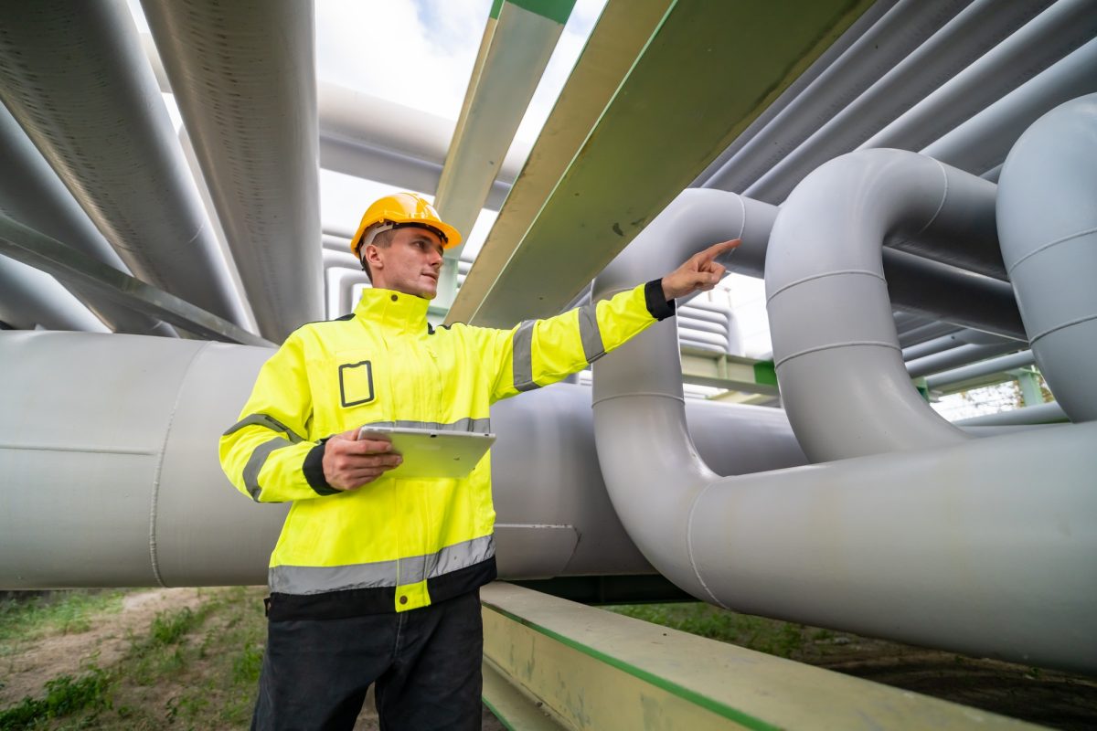 Safety Inspection of Industrial Piping System by Engineer at Construction Site